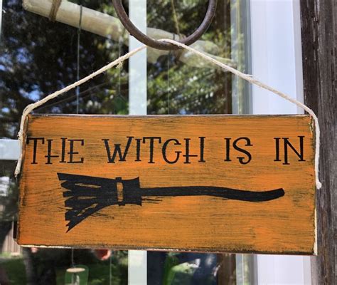 Make a spooky statement with a witch-themed wall sign from Ashland